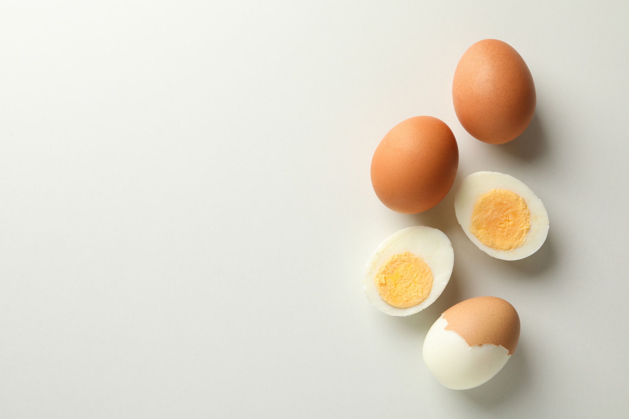 Boiled eggs on white background, top view