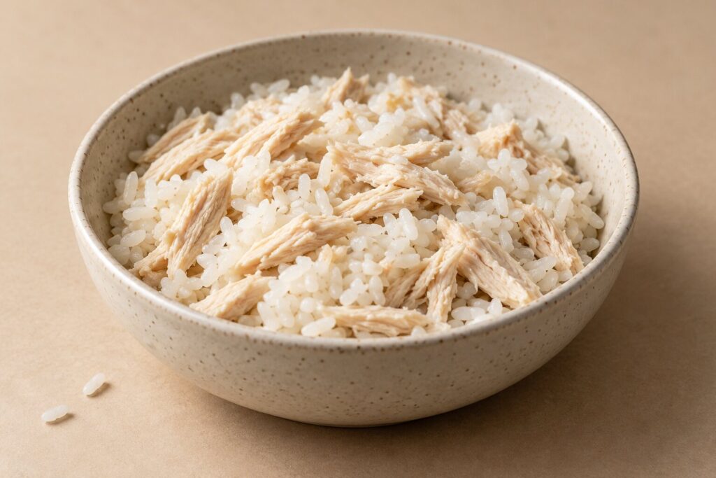 Can Dogs Eat Rice? 2 A bowl of shredded chicken mixed with plain white rice for a bland diet