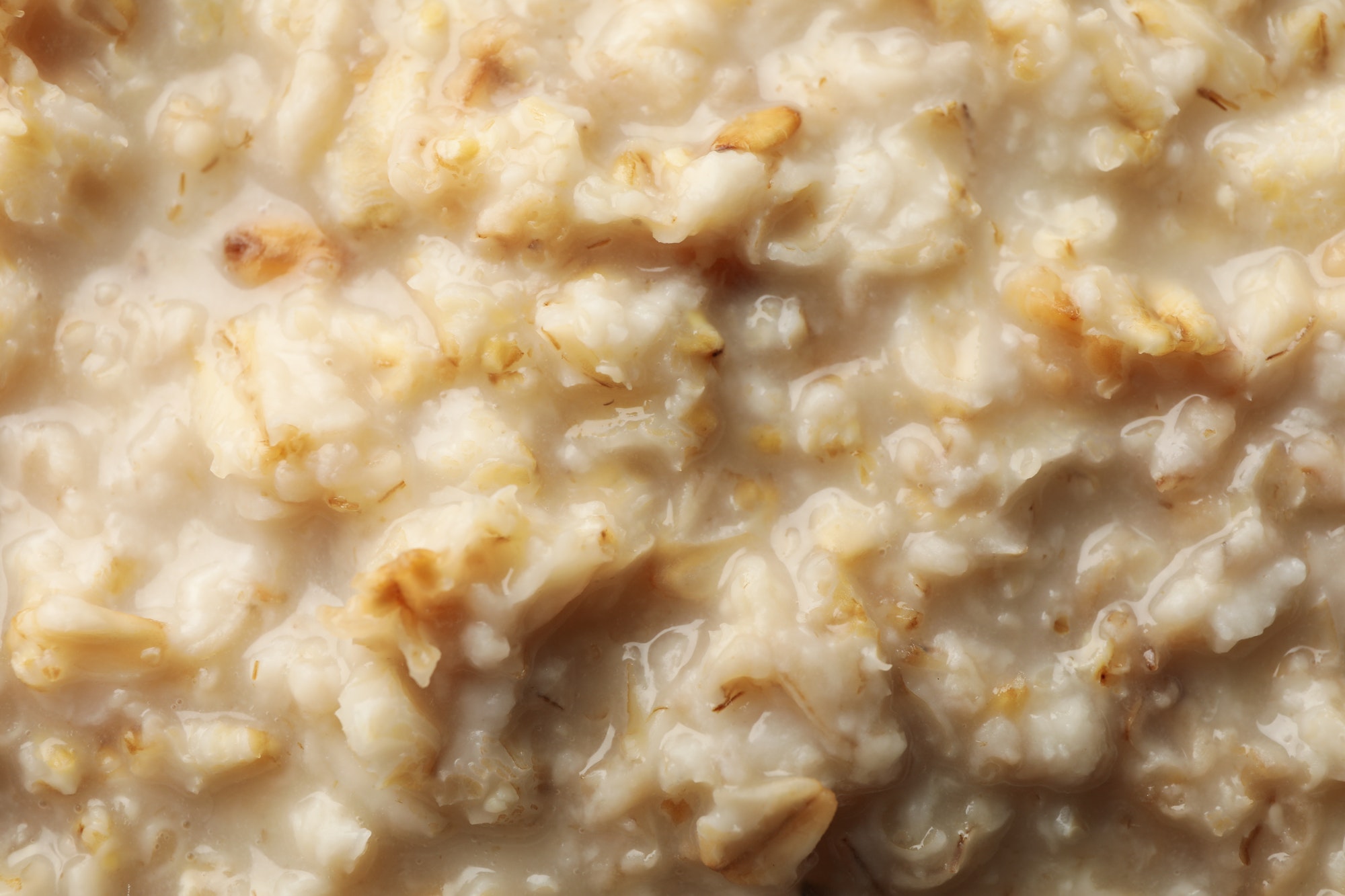 Oatmeal porridge texture on whole background, close up